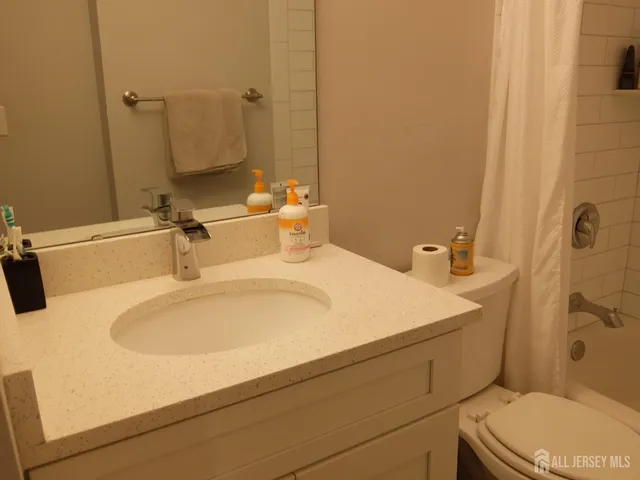 a bathroom with a toilet and a bath tub