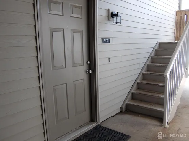 a kitchen with a sink and a stove with wooden floor
