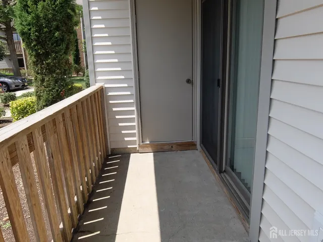 a view of a balcony with wooden floor