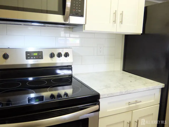 a kitchen with a stove and a microwave