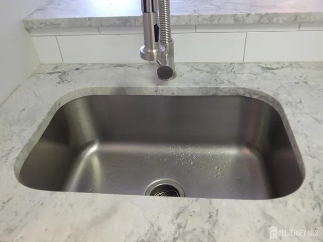 a stove top oven sitting inside of a kitchen