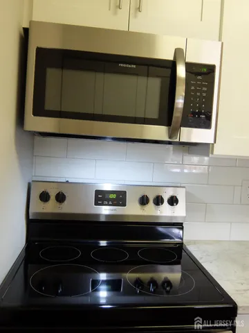 a view of a workspace with furniture and a mirror