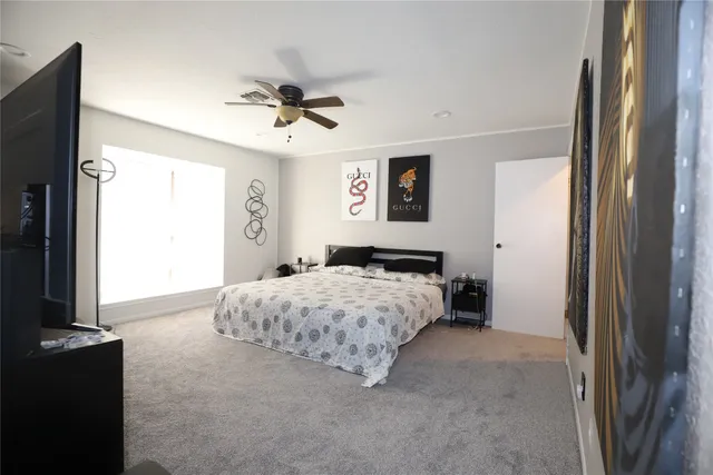 a bedroom with a bed and window