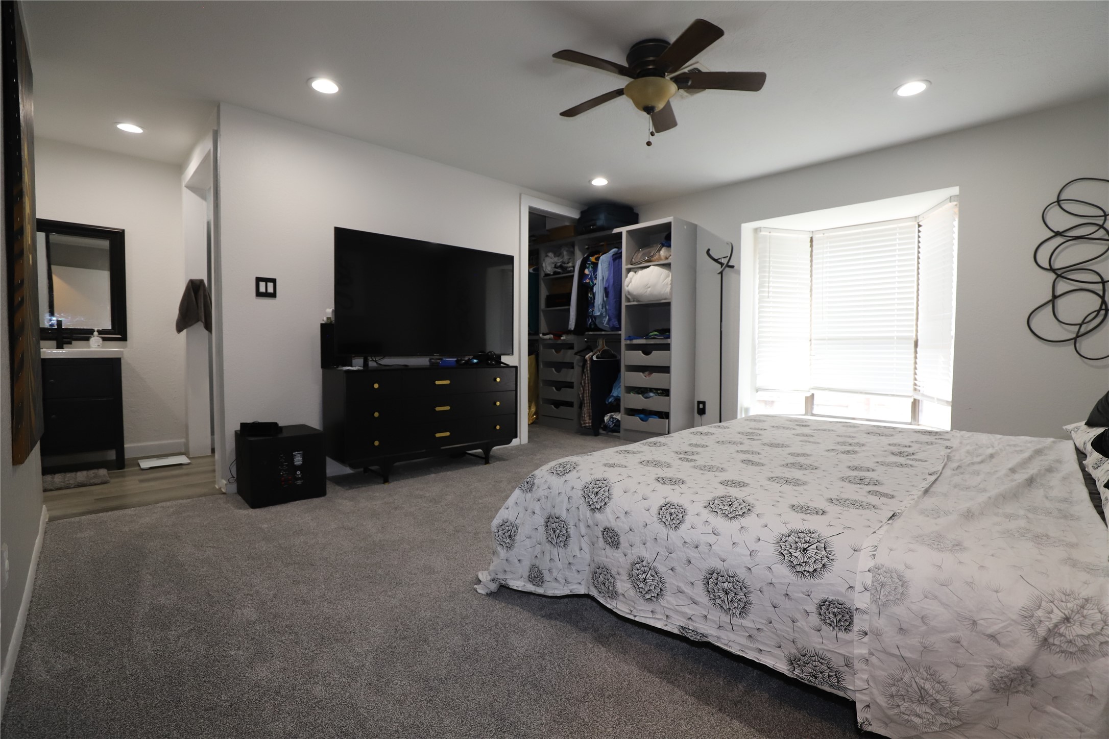 2103 Place Rebecca Lane, Unit D6 Houston, TX 77090 - Photo 15 of 31 a bedroom with a bed and a flat tv screen on dresser