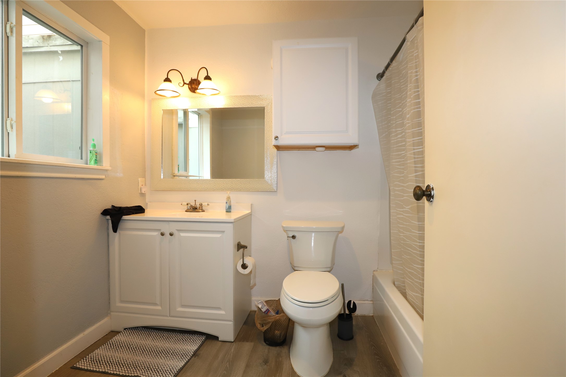 2103 Place Rebecca Lane, Unit D6 Houston, TX 77090 - Photo 17 of 31 a bathroom with a toilet sink and mirror