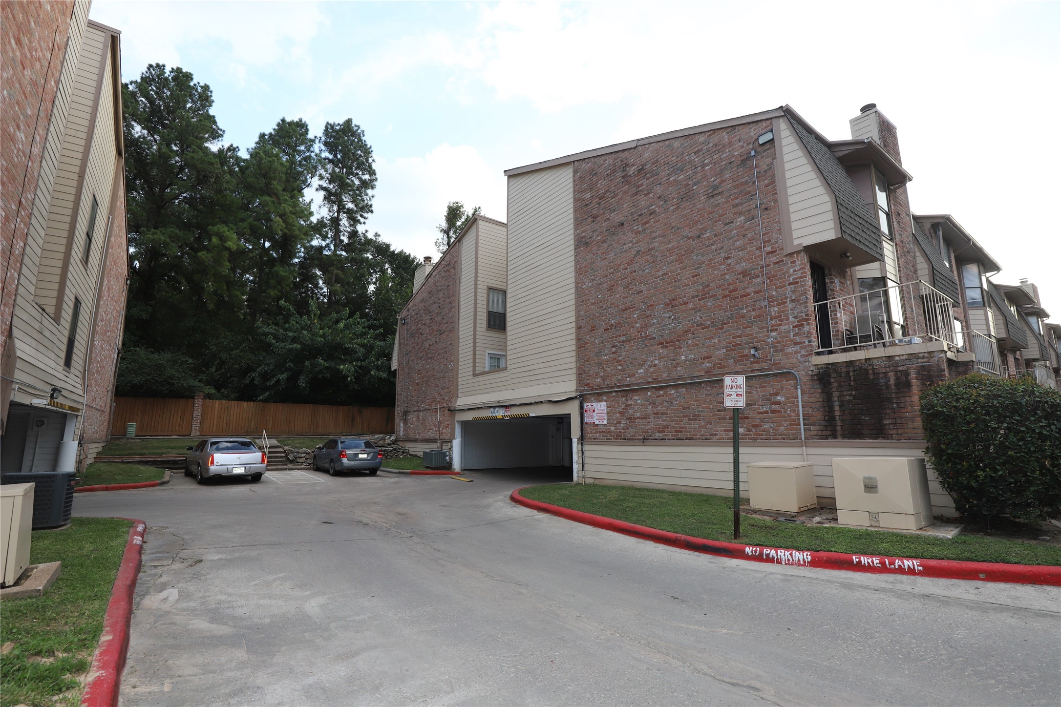 2103 Place Rebecca Lane, Unit D6 Houston, TX 77090 - Photo 23 of 31 a view of a parked cars in front of a house