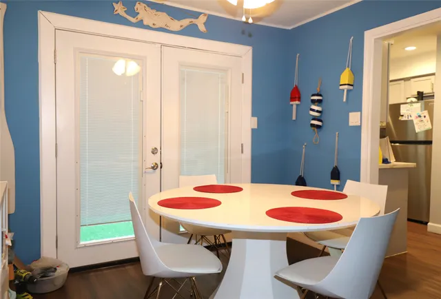a view of a dining room with furniture and wooden floor