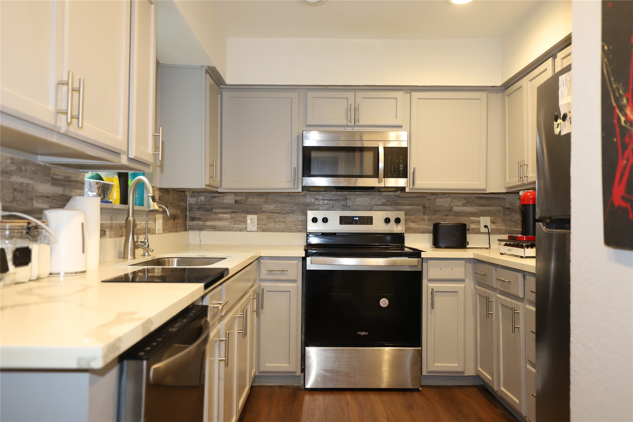 2103 Place Rebecca Lane, Unit D6 Houston, TX 77090 - Photo 5 of 31 a kitchen with a sink stove and microwave