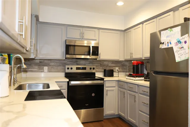 a kitchen with a sink a stove and cabinets