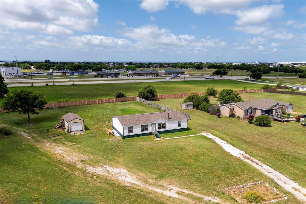 1406 Grand Prix Court Rhome, TX 76078 - Photo 1 of 12 a view of a lake with a house in the background