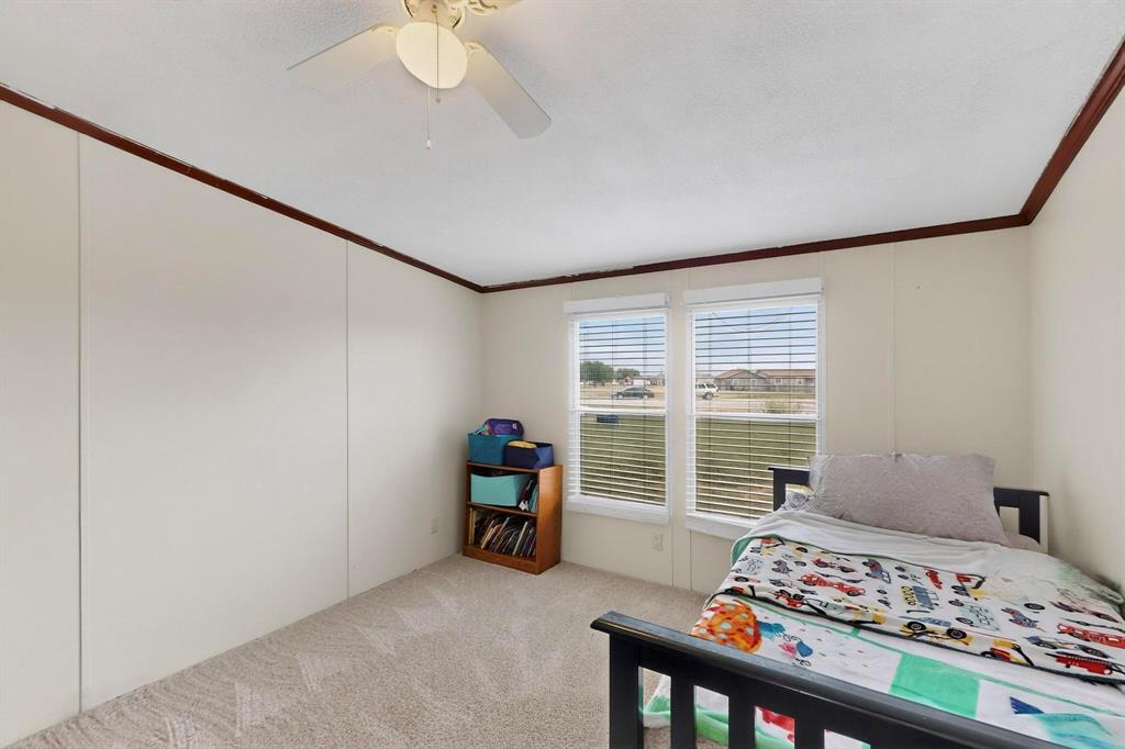 1406 Grand Prix Court Rhome, TX 76078 - Photo 12 of 12 a bedroom with furniture and a window