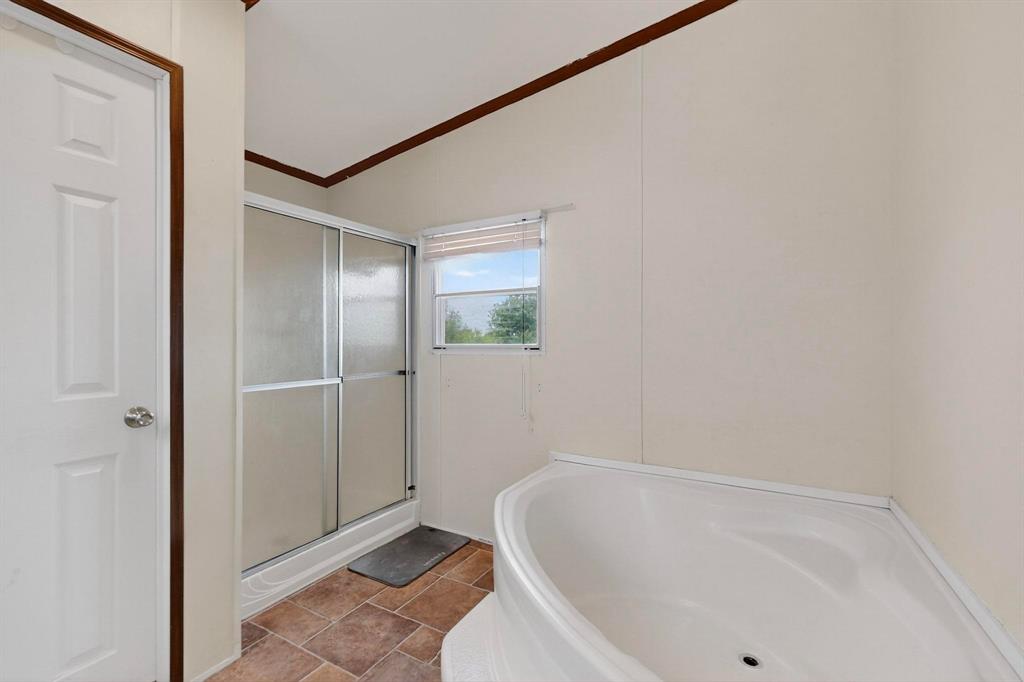 1406 Grand Prix Court Rhome, TX 76078 - Photo 9 of 12 a bathroom with a tub and shower
