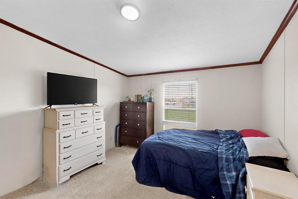 1406 Grand Prix Court Rhome, TX 76078 - Photo 10 of 12 a bedroom with a bed and television