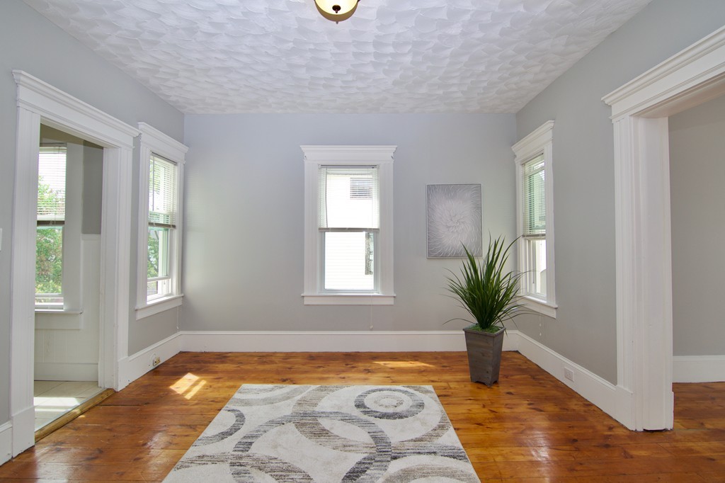 45 Malden Street Springfield, MA 01108 - Photo 16 of 30 a view of a bedroom with wooden floor and potted plant