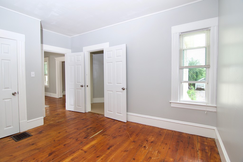 45 Malden Street Springfield, MA 01108 - Photo 20 of 30 an empty room with wooden floor and windows