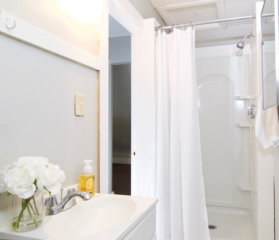 45 Malden Street Springfield, MA 01108 - Photo 27 of 30 a bathroom with a sink mirror and shower