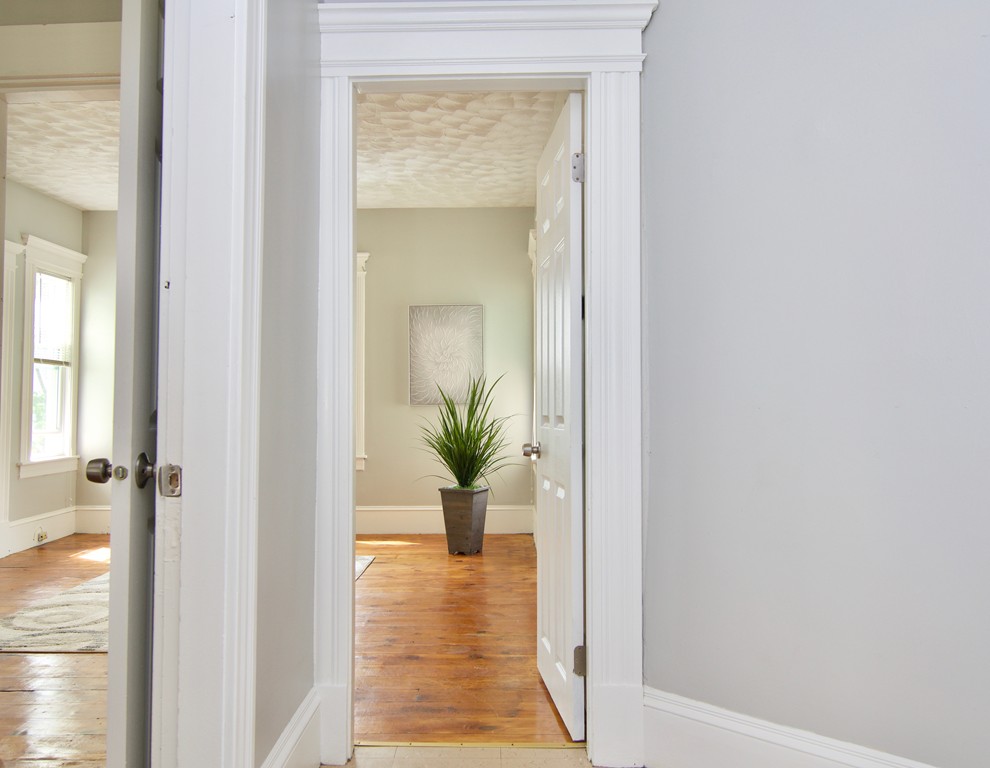 45 Malden Street Springfield, MA 01108 - Photo 6 of 30 a view of a hallway with wooden floor and a living room