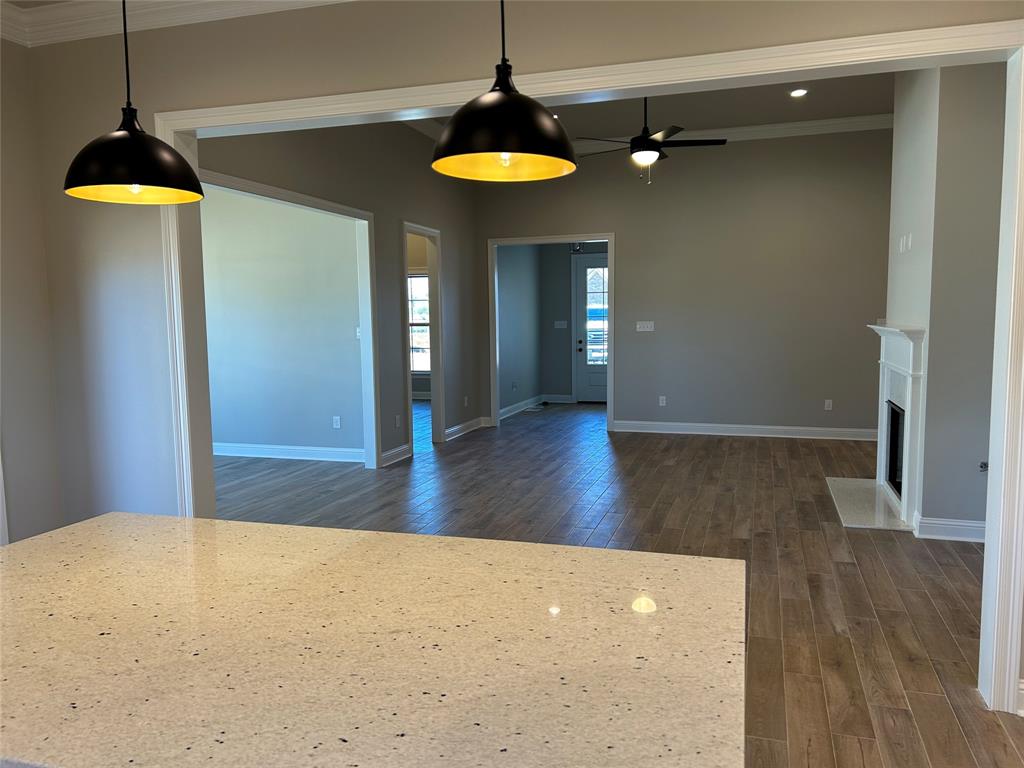 405 Merestone Crossing Benton, LA 71006 - Photo 7 of 22 a view of a room with wooden floor a ceiling fan and a window