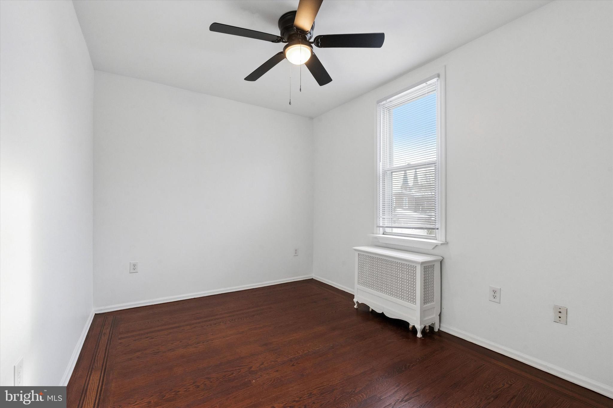 4489 Livingston Street Philadelphia, PA 19137 - Photo 11 of 25 an empty room with wooden floor ceiling fan and window