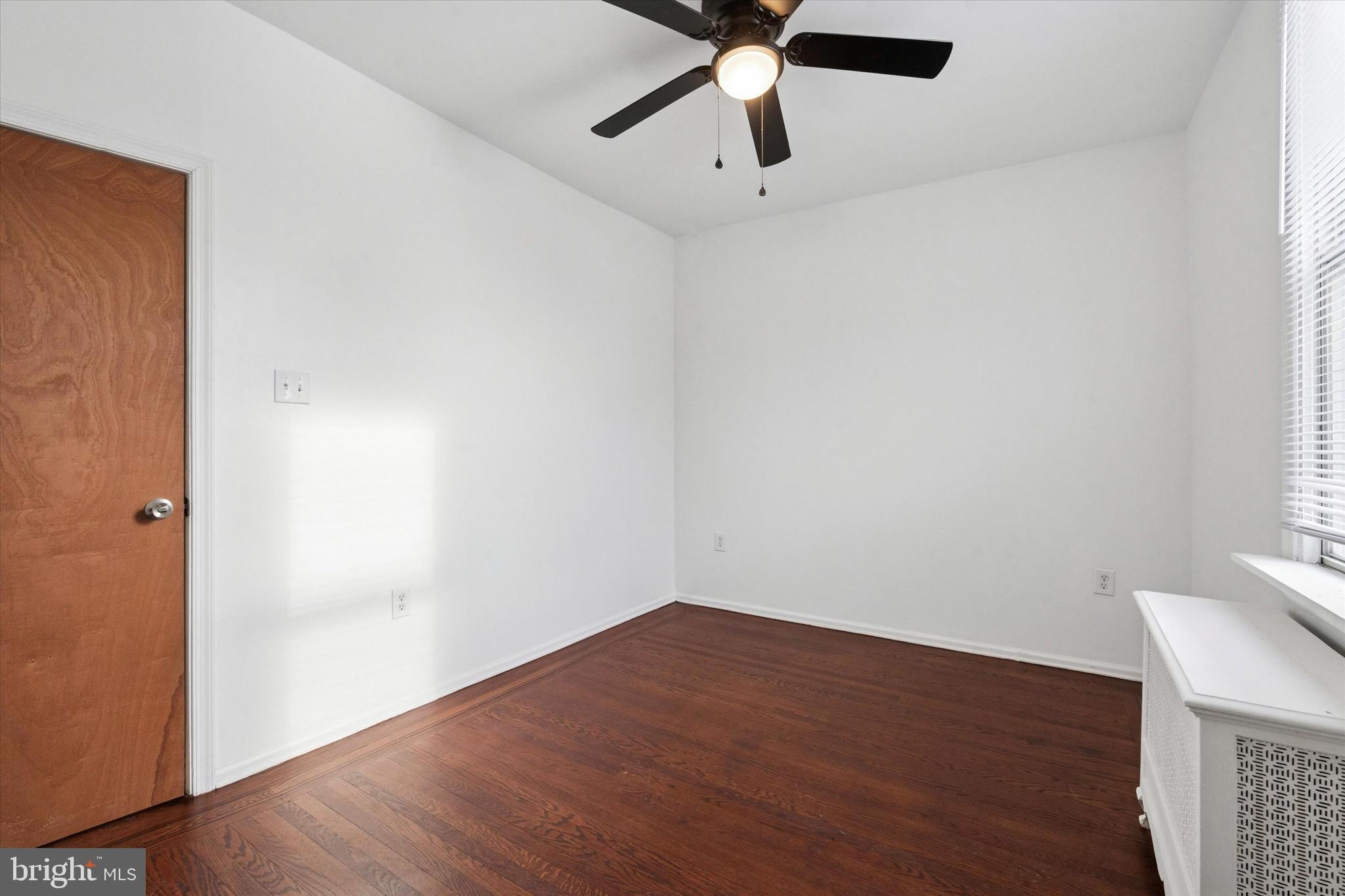 4489 Livingston Street Philadelphia, PA 19137 - Photo 12 of 25 an empty room with a window and a ceiling fan