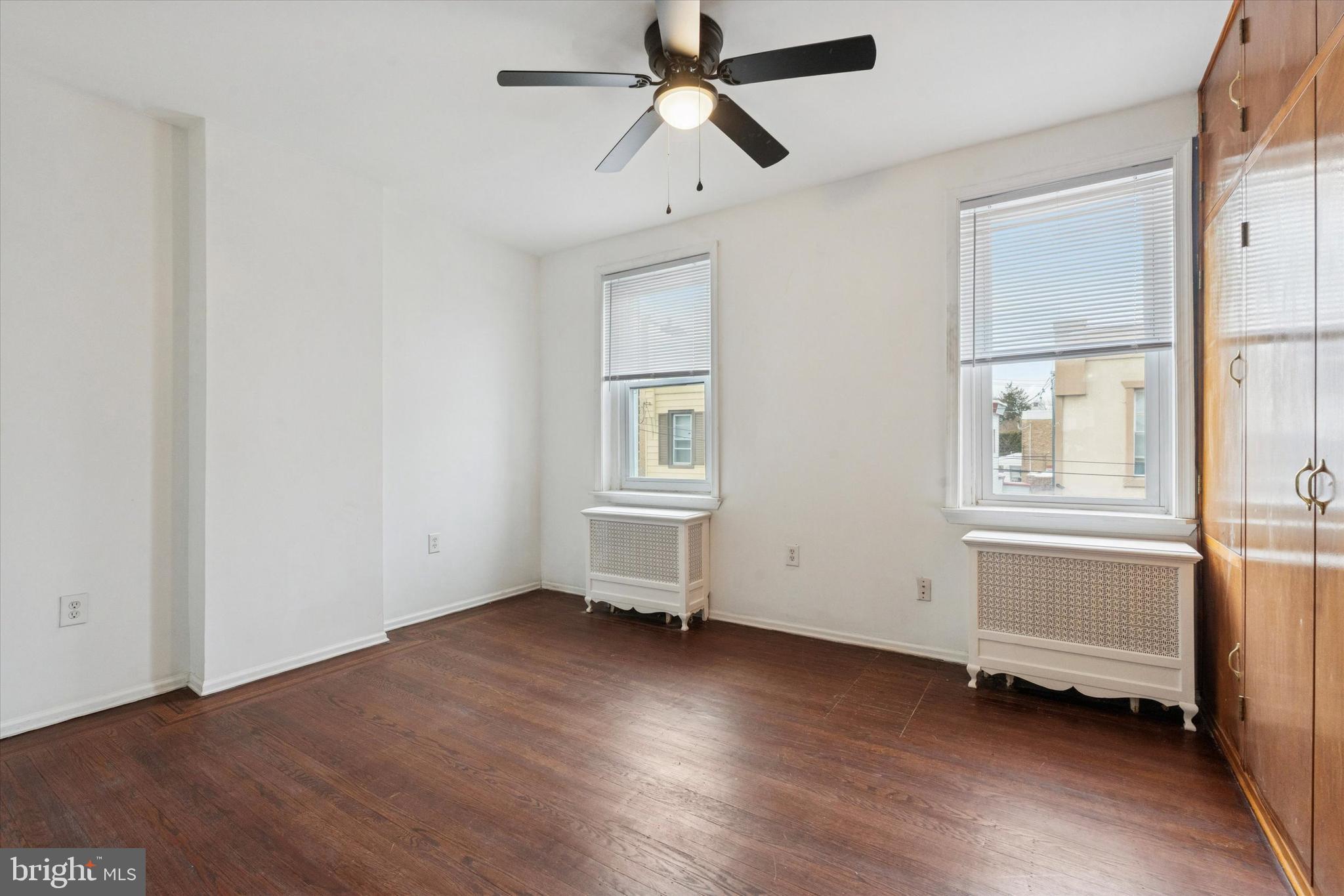 4489 Livingston Street Philadelphia, PA 19137 - Photo 16 of 25 an empty room with wooden floor and windows