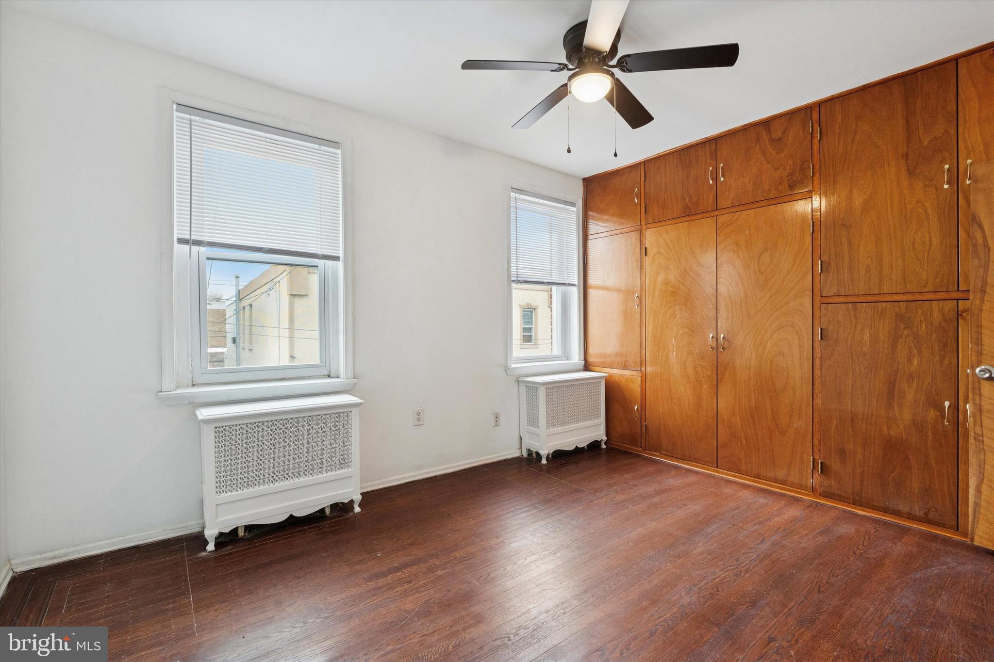4489 Livingston Street Philadelphia, PA 19137 - Photo 19 of 25 an empty room with wooden floor fan and windows