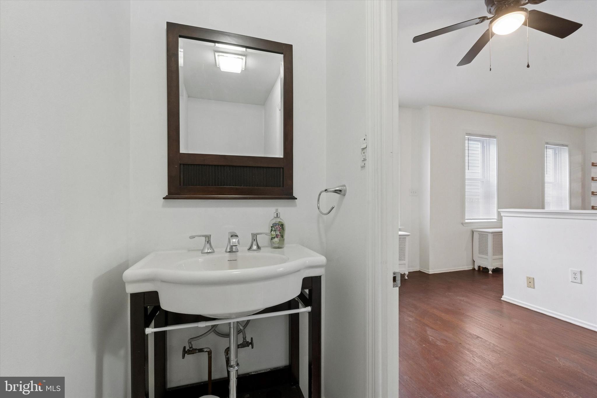 4489 Livingston Street Philadelphia, PA 19137 - Photo 8 of 25 a bathroom with a sink and a mirror