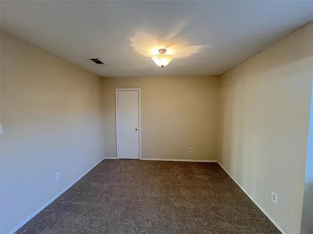 an empty room with a empty space and windows