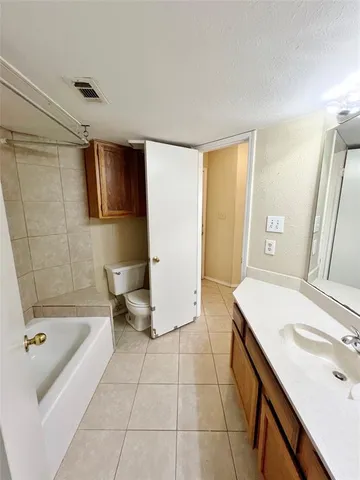 a bathroom with a tub sink and a mirror