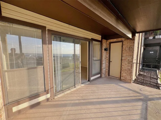 a view of a porch with a table and chairs
