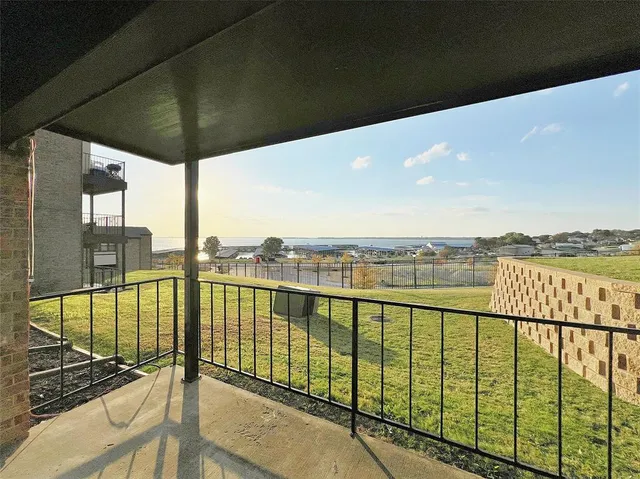 a view of a swimming pool with a lake from a balcony