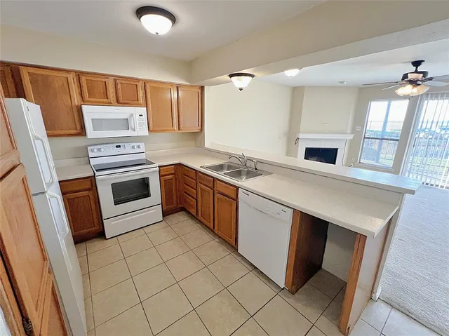 a kitchen with a stove a sink and a refrigerator