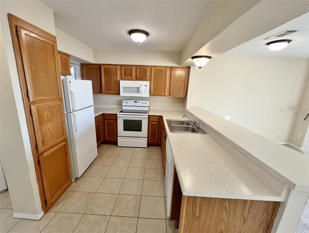 a kitchen with a refrigerator sink and stove