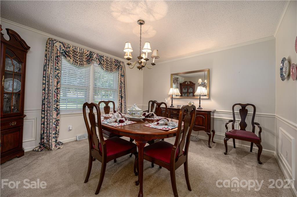 628 Hulls Grove Church Road Vale, NC 28168 - Photo 5 of 40 a dining room with furniture a chandelier and window