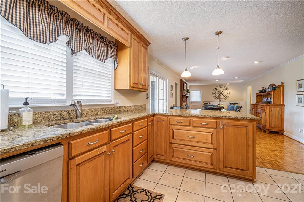 628 Hulls Grove Church Road Vale, NC 28168 - Photo 8 of 40 a kitchen with stainless steel appliances granite countertop a sink and dishwasher a stove top oven with wooden floor