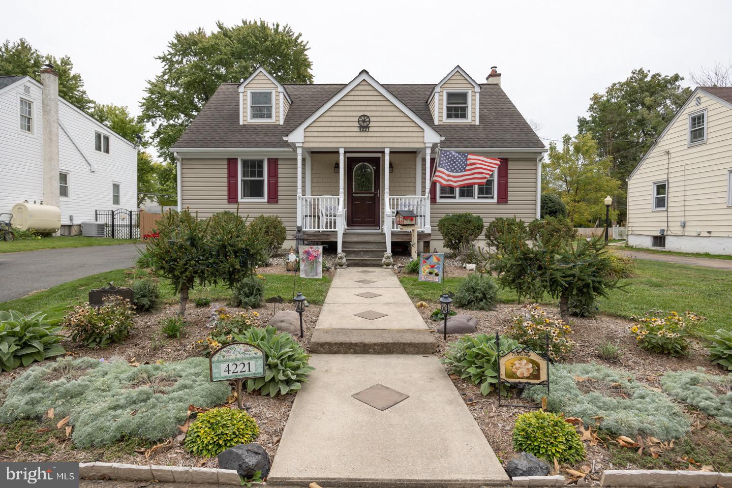 a front view of a house with a garden and porch