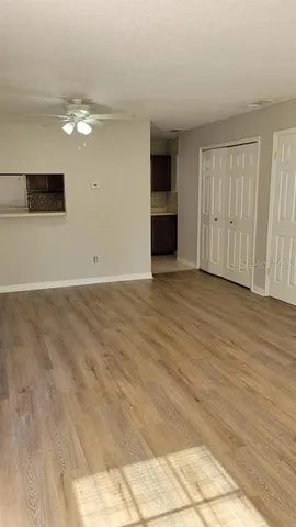 a view of an empty room with a kitchen