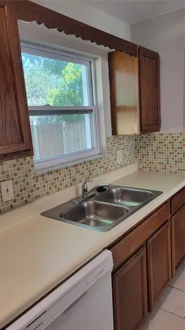 a kitchen with a sink and a window