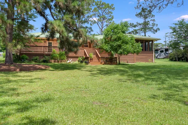a view of a house with a backyard