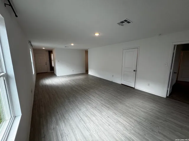 a view of a hallway with wooden floor