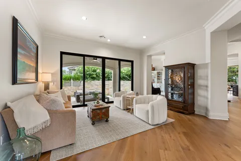 a living room with furniture and large windows