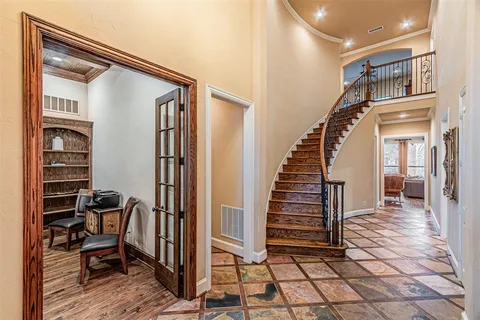 a view of a hallway with wooden floor and windows