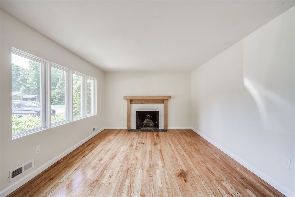 56 Audley Road Springfield, MA 01118 - Photo 12 of 37 a view of an empty room with a window and wooden floor