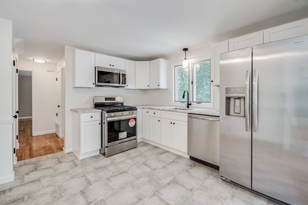 56 Audley Road Springfield, MA 01118 - Photo 3 of 37 a kitchen with stainless steel appliances a refrigerator sink and microwave