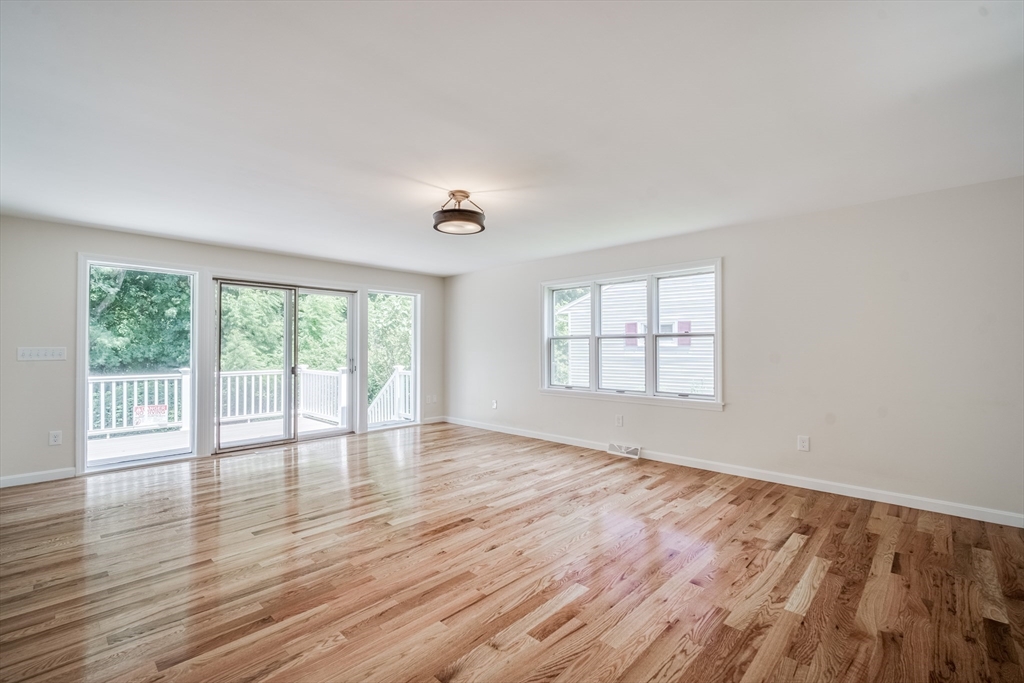 56 Audley Road Springfield, MA 01118 - Photo 4 of 37 a view of an empty room with wooden floor and a window