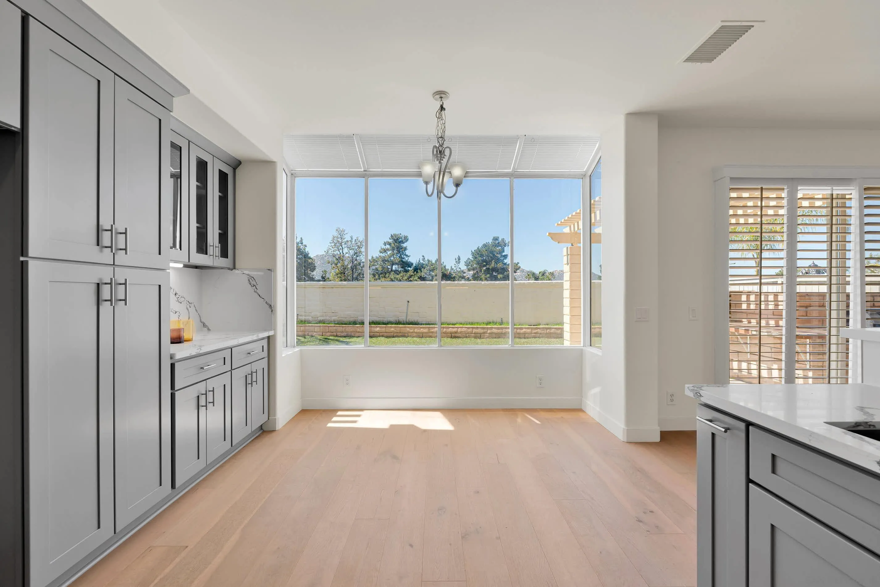 45441 Camino Monzon Temecula, CA 92592 - Photo 15 of 53 a view of a kitchen with a sink and dishwasher with wooden floor