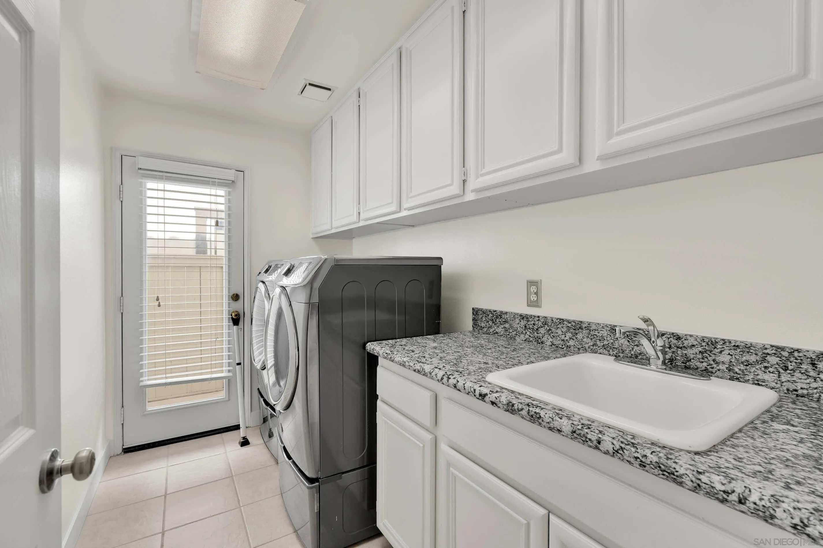45441 Camino Monzon Temecula, CA 92592 - Photo 20 of 53 a bathroom with a granite countertop sink and washing machine