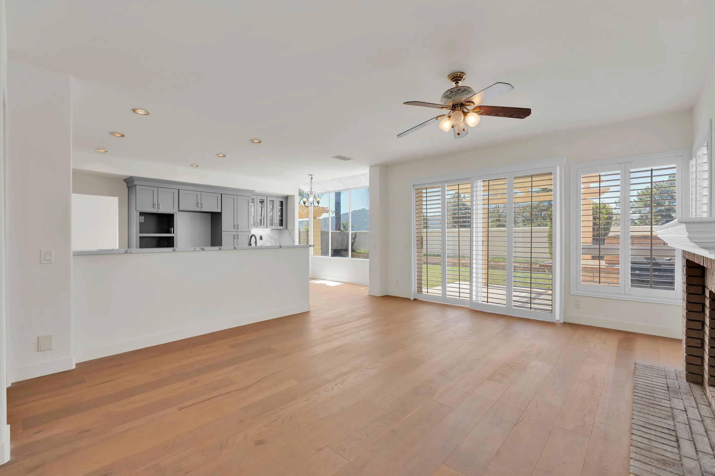 45441 Camino Monzon Temecula, CA 92592 - Photo 29 of 53 a view of a kitchen with wooden floor and a fireplace