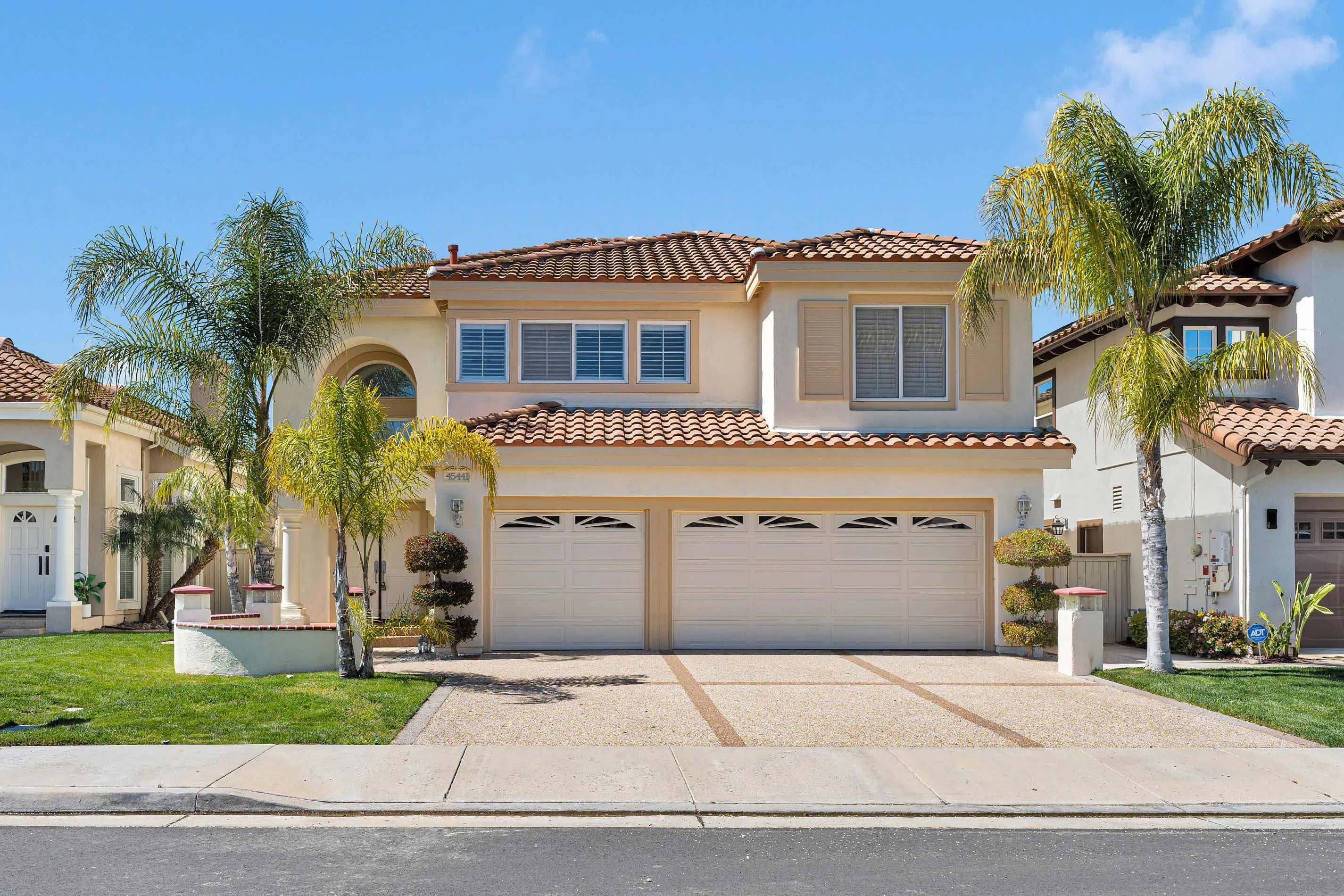45441 Camino Monzon Temecula, CA 92592 - Photo 3 of 53 a front view of a house with a garden and a garage