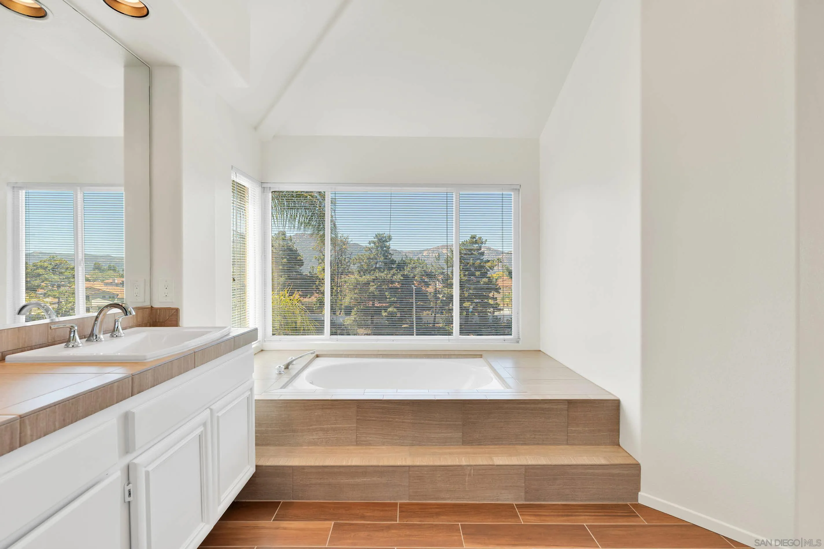 45441 Camino Monzon Temecula, CA 92592 - Photo 35 of 53 a spacious bathroom with a tub sink and mirror